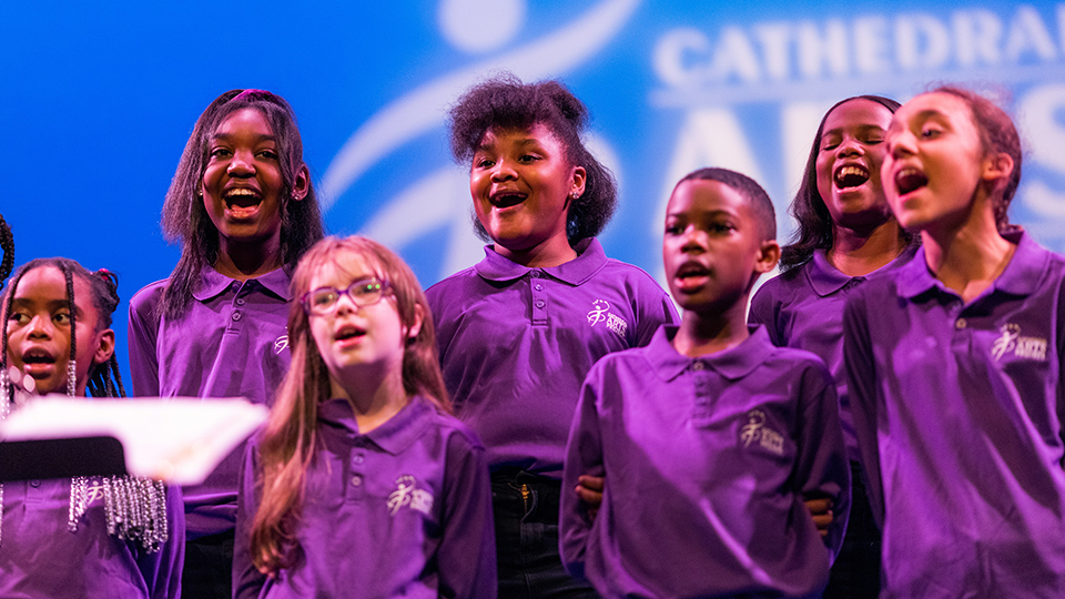 CAP students sing on a stage